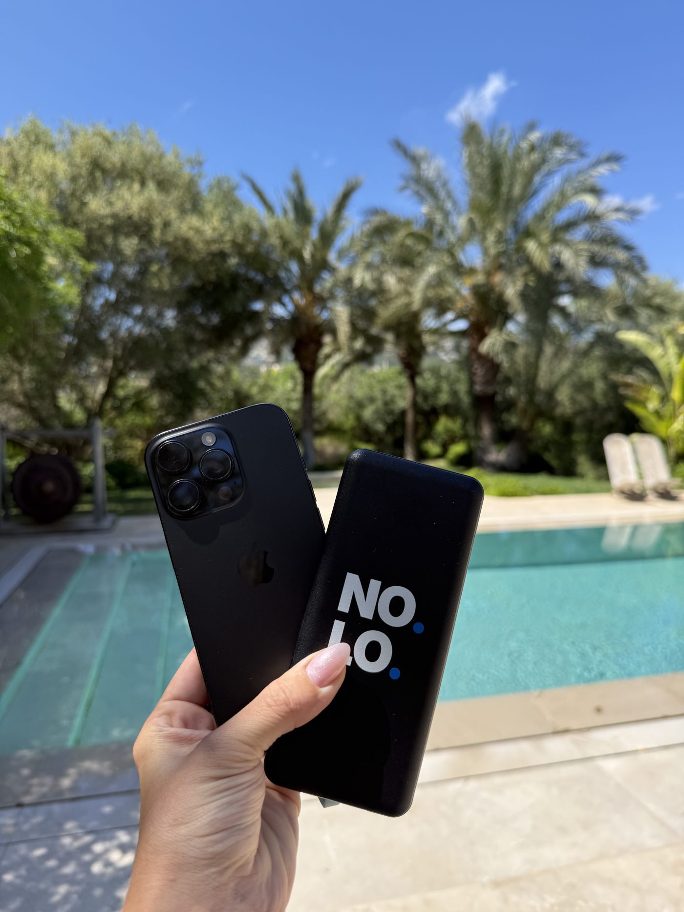 By the pool in Mallorca with a NOLO powerbank in hand